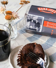 Load image into Gallery viewer, Breakfast Brownies on a table with a fork and coffee