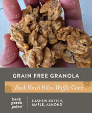 Load image into Gallery viewer, A handful of waffle cone granola clusters. Grain Free Granola by Nana Joes Granola in collaboration with Back Porch Paleo. Back Porch Paleo Waffle Cone Granola Blend: Cashew Butter, Maple, Almond.