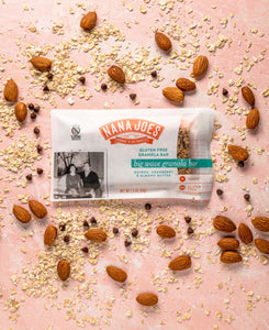 Big Wave Bar by Nana Joes Granola, front on pink background with almonds and quinoa