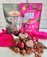 Load image into Gallery viewer, Chocolate Cherry Crunch Granola with heart-shaped chocolates and cherries, paired with Nana Joes Granola and BTR Nation packages.
