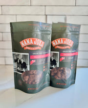 Load image into Gallery viewer, Two packages of Nana Joe&#39;s grain-free granola on a white surface with a tiled wall background. Chocolate Cherry Crunch.
