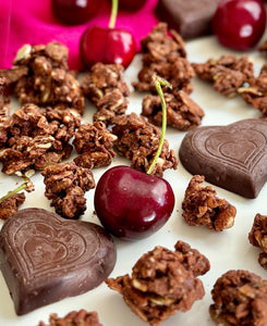 Nana Joe's granola with cherries and BTR Nation chocolate hearts on a pink cloth