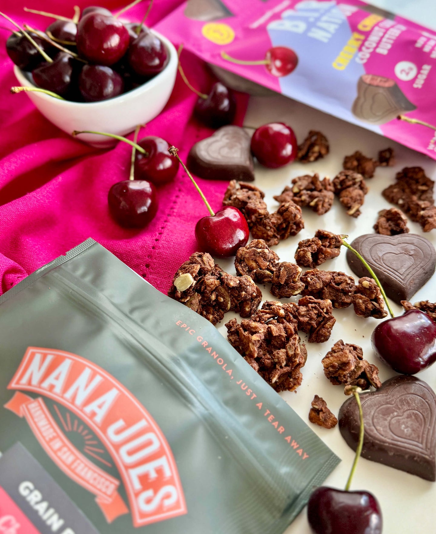 Nana Joe's granola with cherries and BTR Nation chocolate hearts on a pink cloth