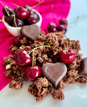 Load image into Gallery viewer, Nana Joe&#39;s granola with cherries and BTR Nation chocolate hearts on a pink cloth
