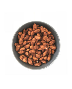 A bowl of Cumin Spiced Almonds by Nana Joes Granola on a white table