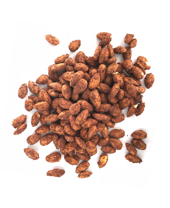 A pile of Cumin Spiced Almonds by Nana Joes Granola on a white table
