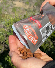 Load image into Gallery viewer, A bag of Cumin Spiced Almonds by Nana Joes Granola being poured into a hand
