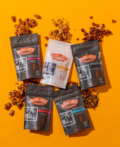 Nana Joes Granola starter pack, bags laid down and spilled on bright orange background