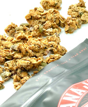 Load image into Gallery viewer, Oat Texas Twisted Praline Gluten Free Granola, Nana Joes Granola close-up spilled onto a white table.
