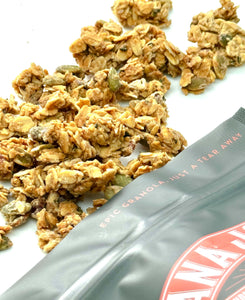 Oat Texas Twisted Praline Gluten Free Granola, Nana Joes Granola close-up spilled onto a white table.