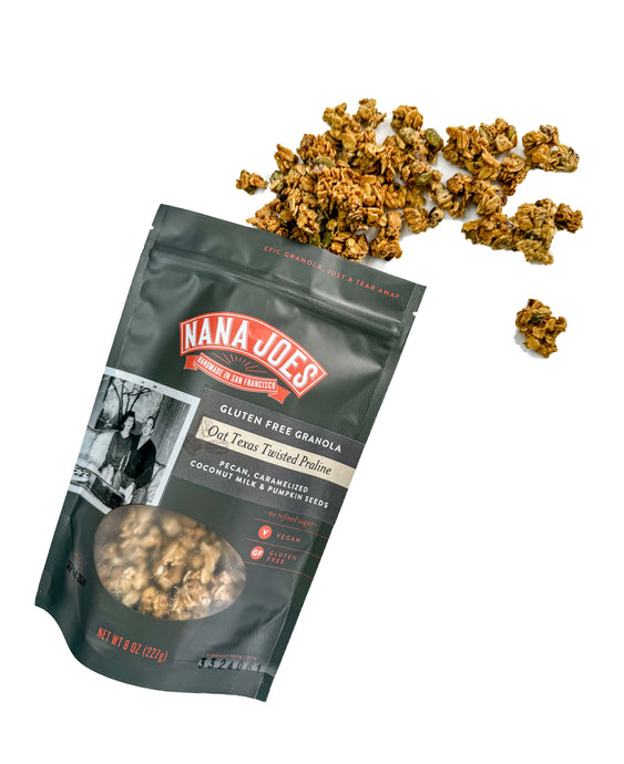 Oat Texas Twisted Praline Gluten Free Granola spilling from back onto white background