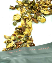 Load image into Gallery viewer, Paleo Texas Twisted Praline blend by Nana Joes Granola spilled on a white table
