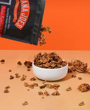 Load image into Gallery viewer, Nana Joes Granola Paleo Sunrise Orange granola pours into a white bowl on an orange background
