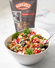Load image into Gallery viewer, A bowl of salad and a bag of Nana Joes Granola Paleo Orange Blend
