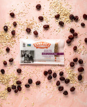 Load image into Gallery viewer, Stoke Granola Bar by Nana Joes Granola on a pink background with cranberries
