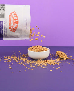 Nana Joes Granola Organic Savory Muesli Blend pouring into white bowl on purple background