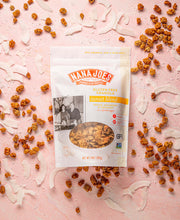Load image into Gallery viewer, Nana Joes Granola gluten-free sunset blend granola package on a pink background.
