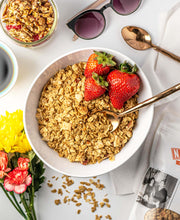 Load image into Gallery viewer, Bowl of granola with strawberries on a white table.

